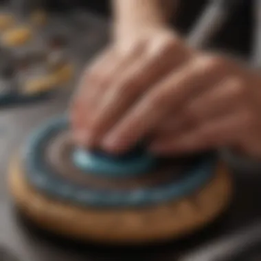 Applying Glue to Cabochon Detailed shot of a cabochon being adhered to a base with glue
