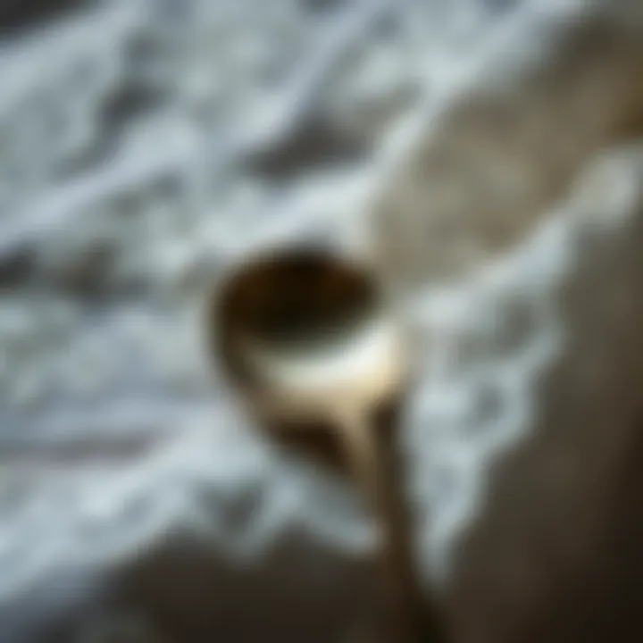 An old silver spoon resting on a delicate lace fabric