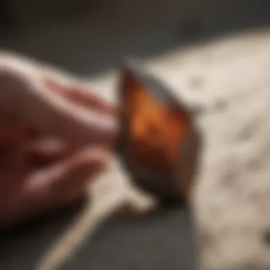 A person examining an arrowhead under natural light