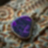 Close-up view of a charoite pendant showcasing its unique purple patterns
