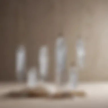 An artistic arrangement of various selenite crystal pendants displayed elegantly on a soft fabric background