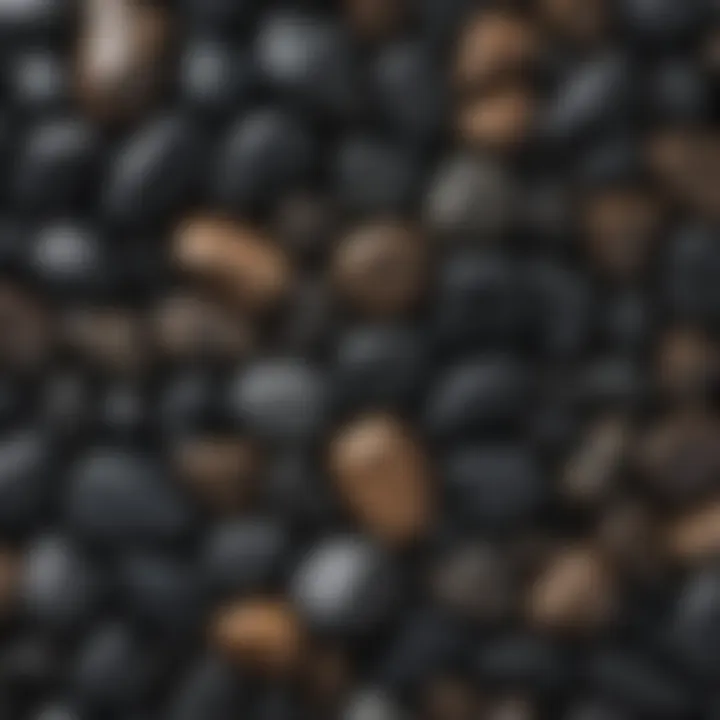 Close-up view of various black tumbled stones showcasing their textures and colors